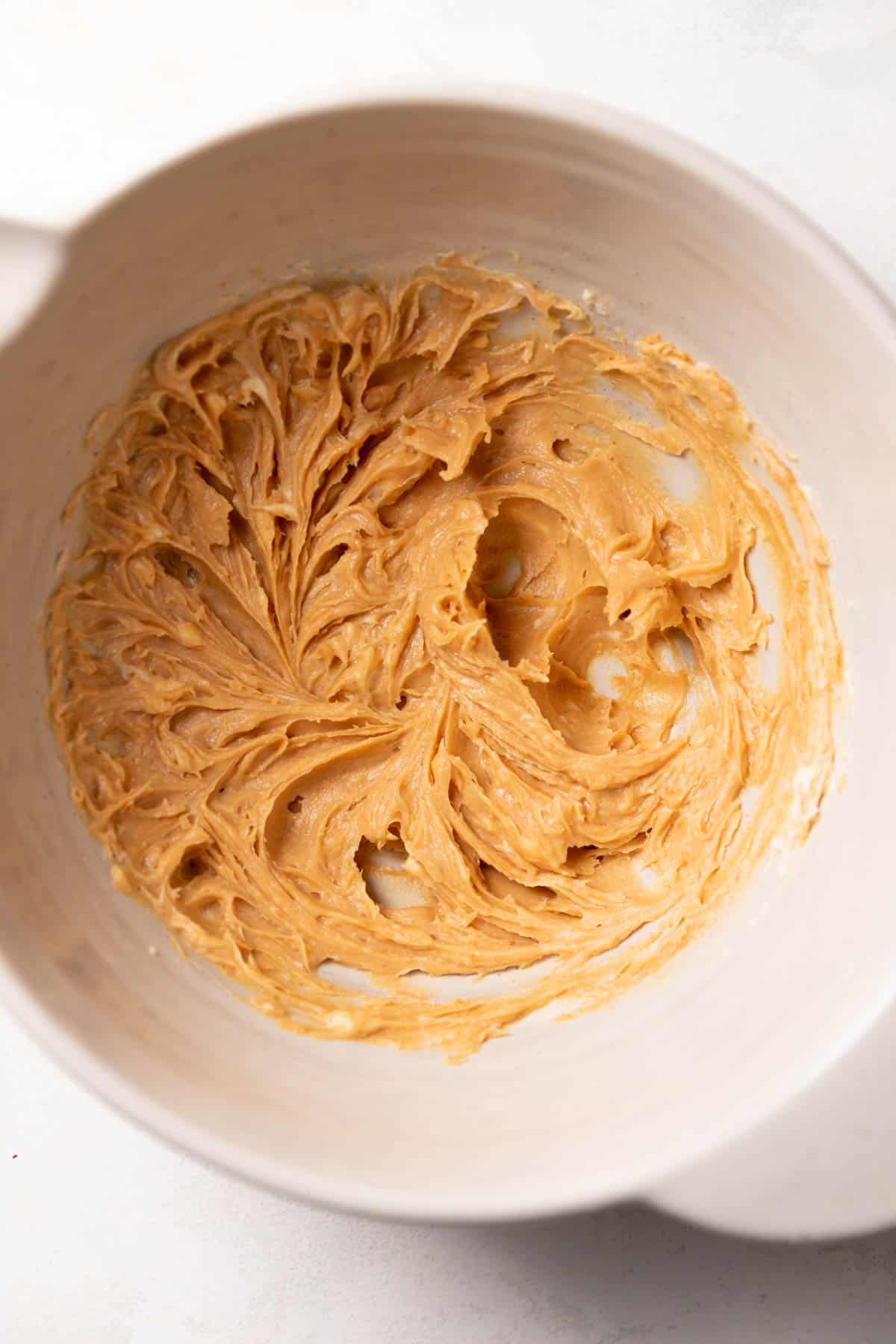 a mixing bowl with peanut butter, miso, and butter creamed together.