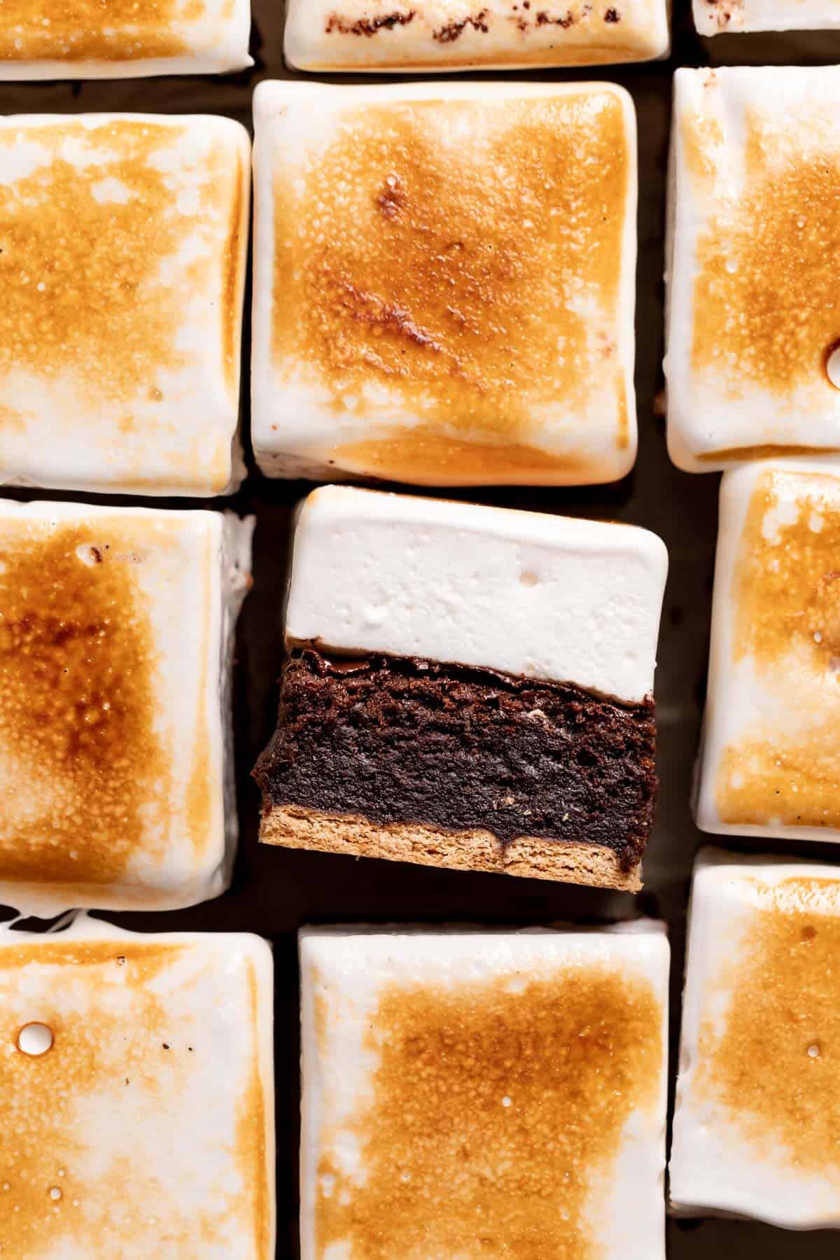 smores brownies layered with graham cracker crust and marshmallow topping.