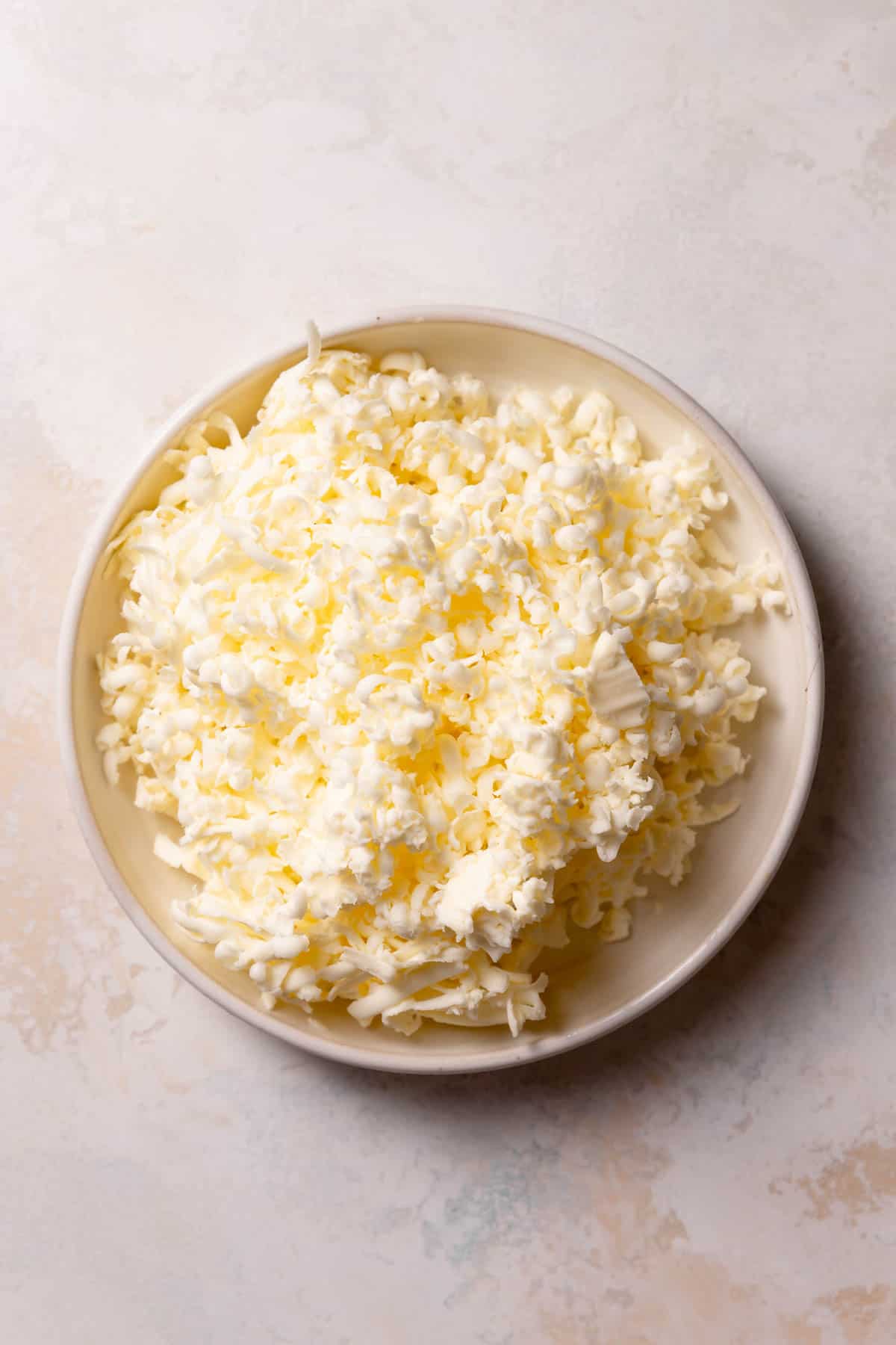 shredded butter in a white bowl.