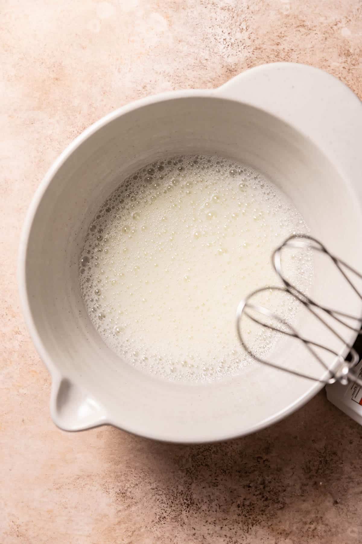 whisked egg whites in a mixing bowl.