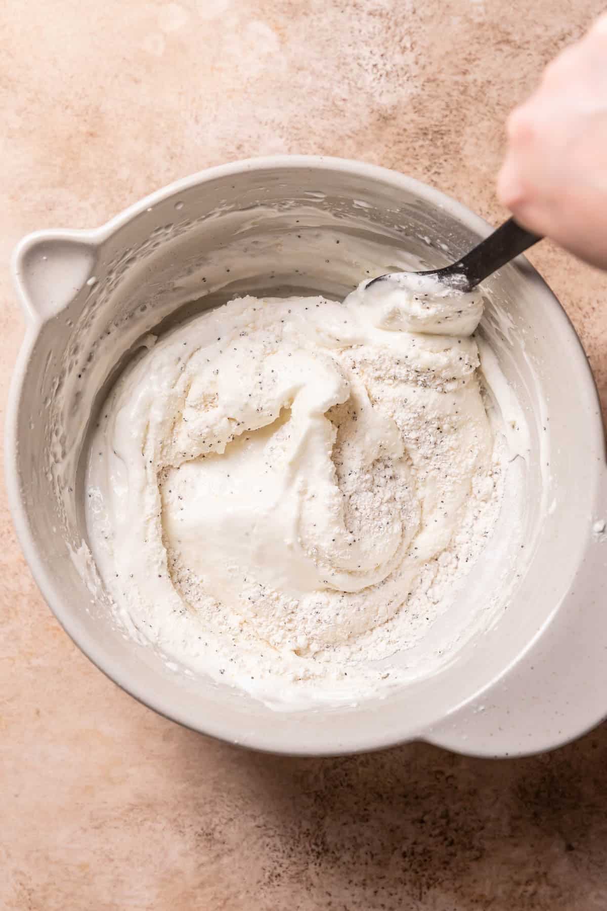 a spatula folding dry ingredients into the meringue