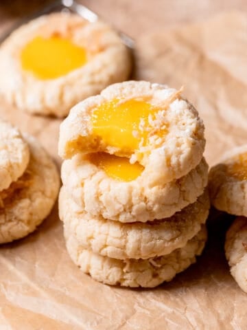 a stack of mango cookies with the top one missing a bite.