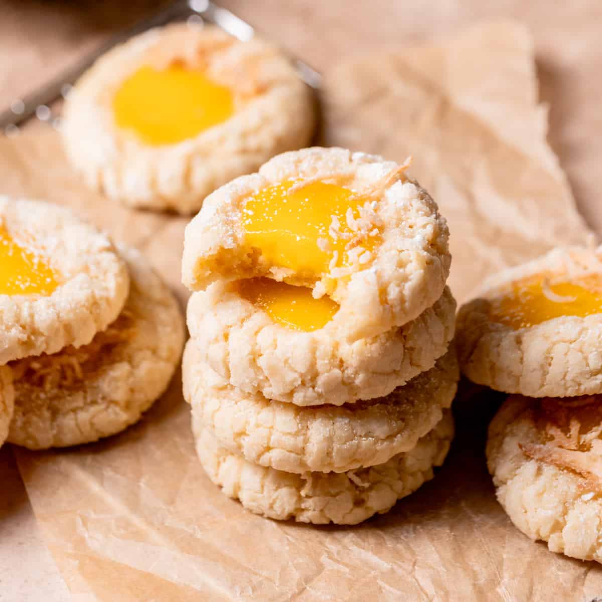 a stack of mango cookies with the top one missing a bite.