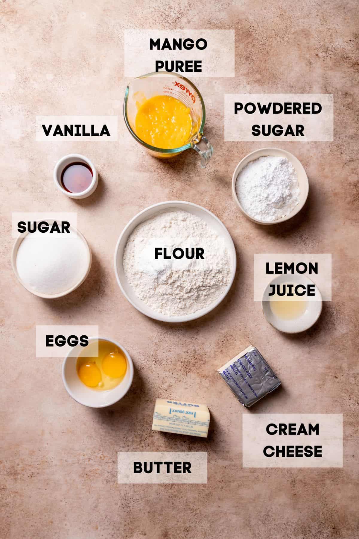 ingredients needed to make mango cookies in bowls with labels.