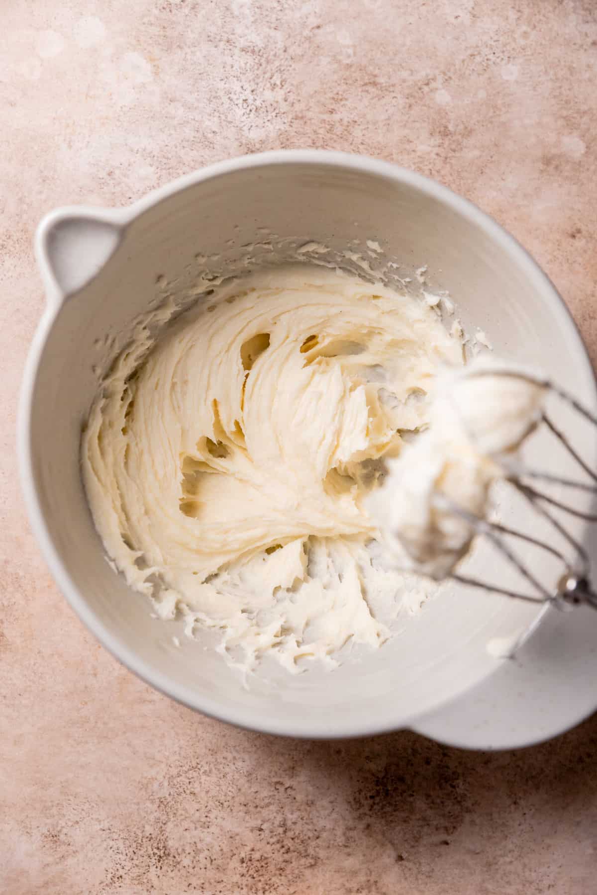 creamed butter, sugar, and cream cheese in a mixing bowl.