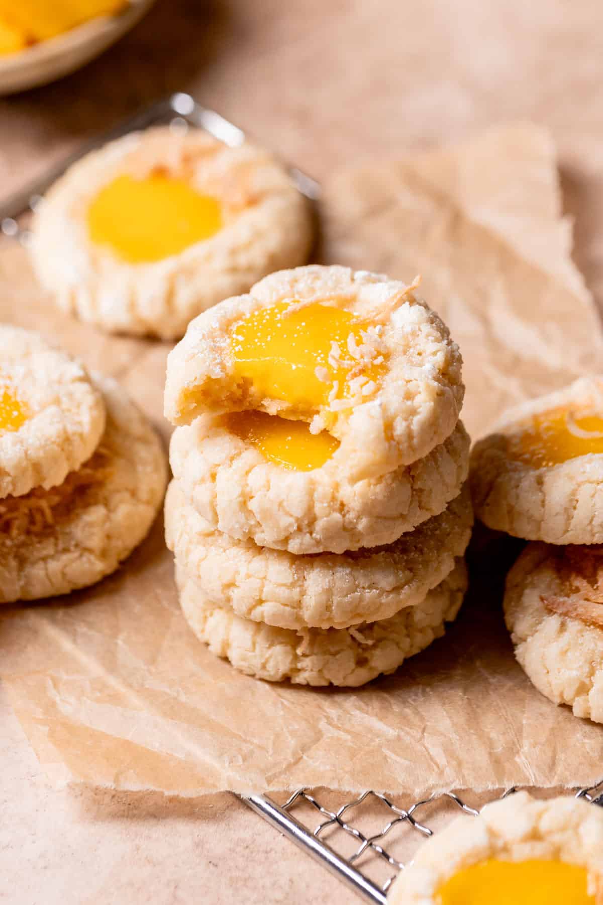 a stack of mango cookies on brown parchment paper.