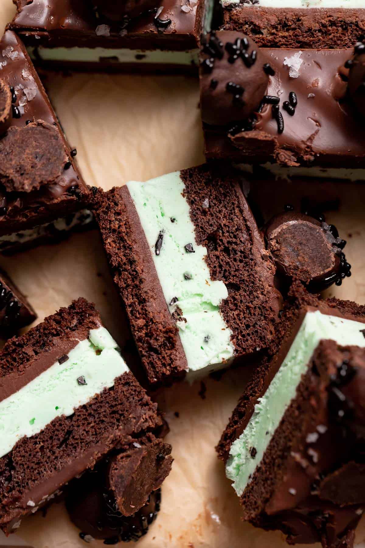 slices of mint chocolate ice cream cake on brown parchment paper.