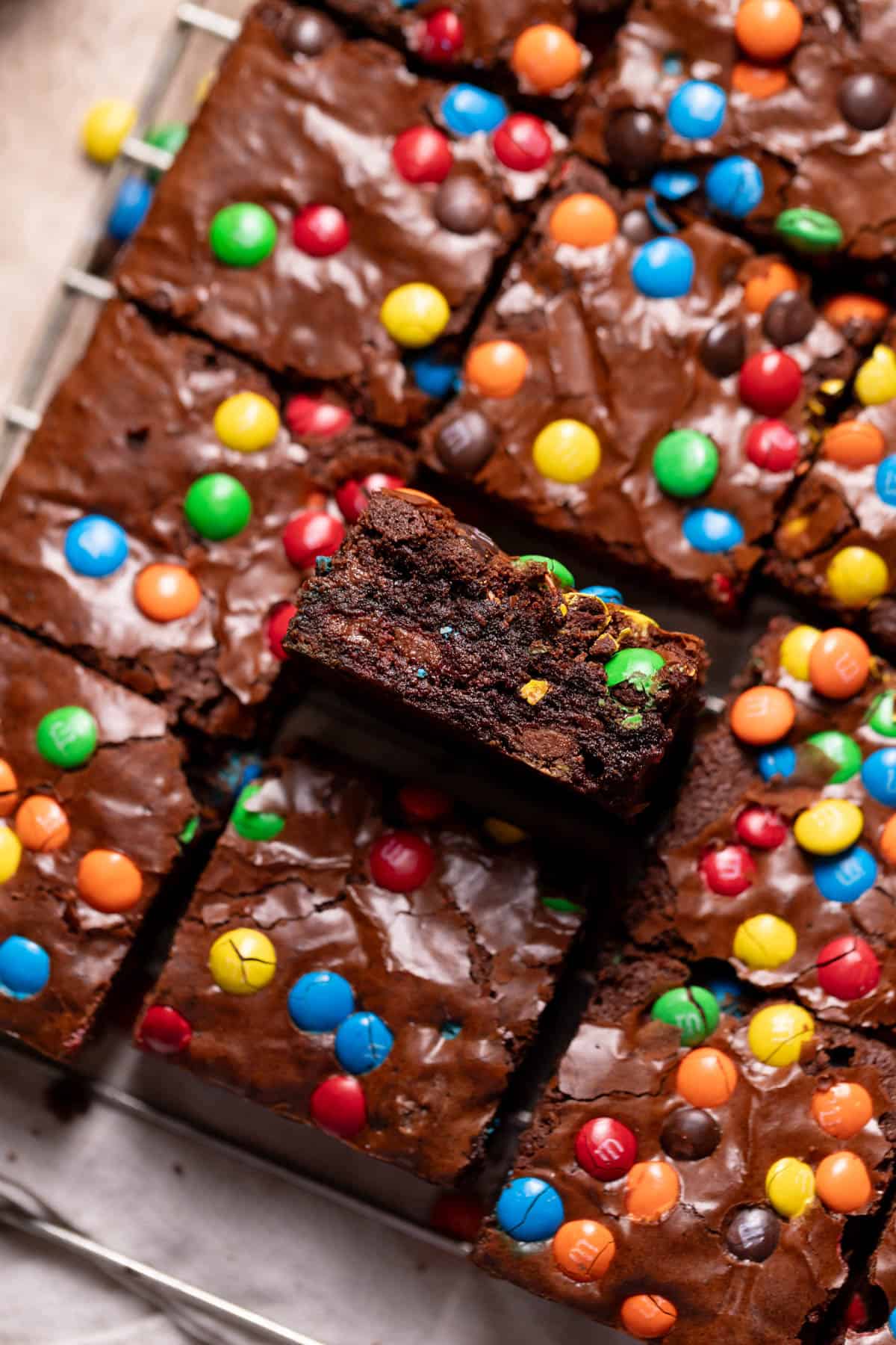 mm brownies on a wire rack with one on its side to show the fudgy texture.