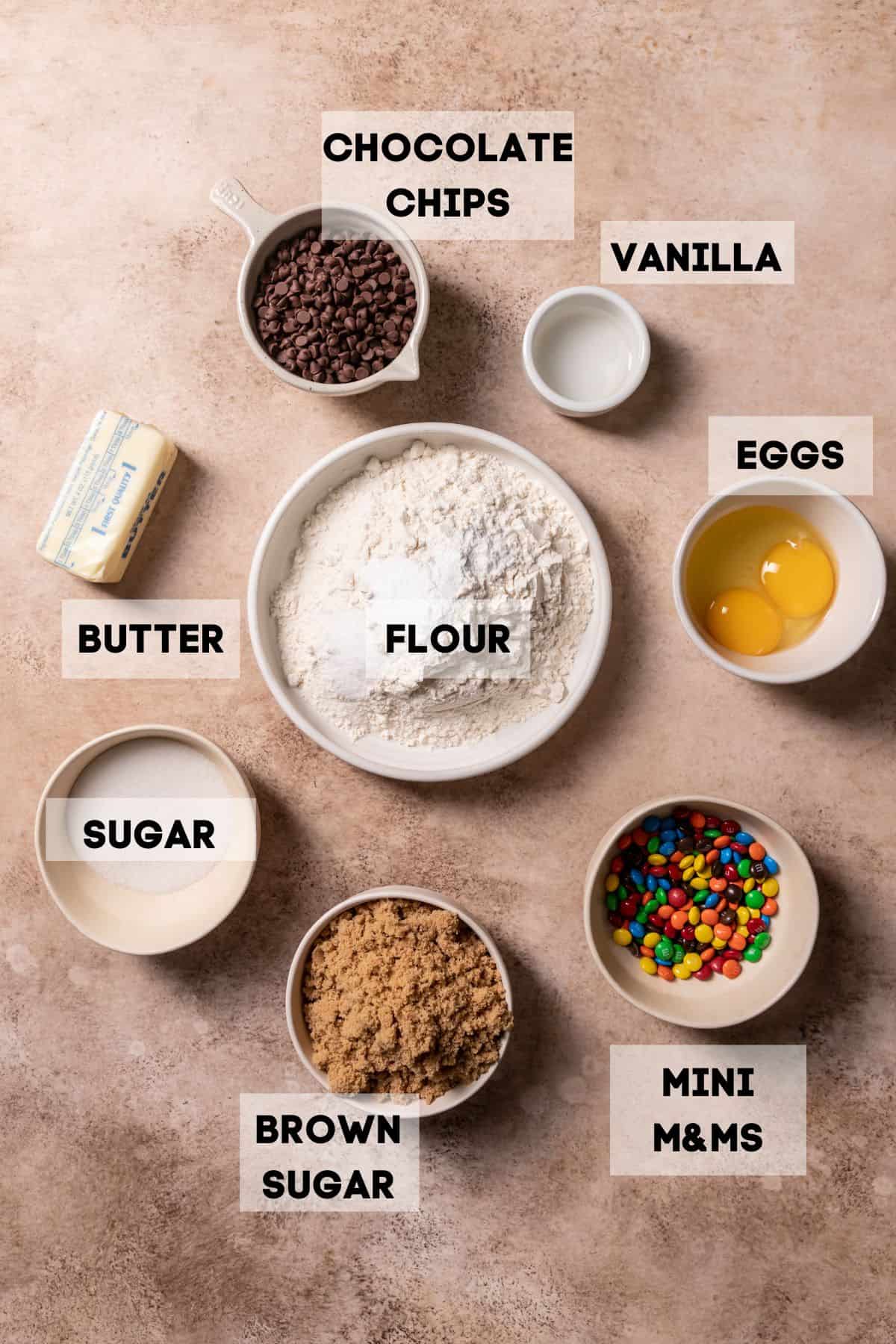 ingredients needed to make mm cookies in bowls with labels.