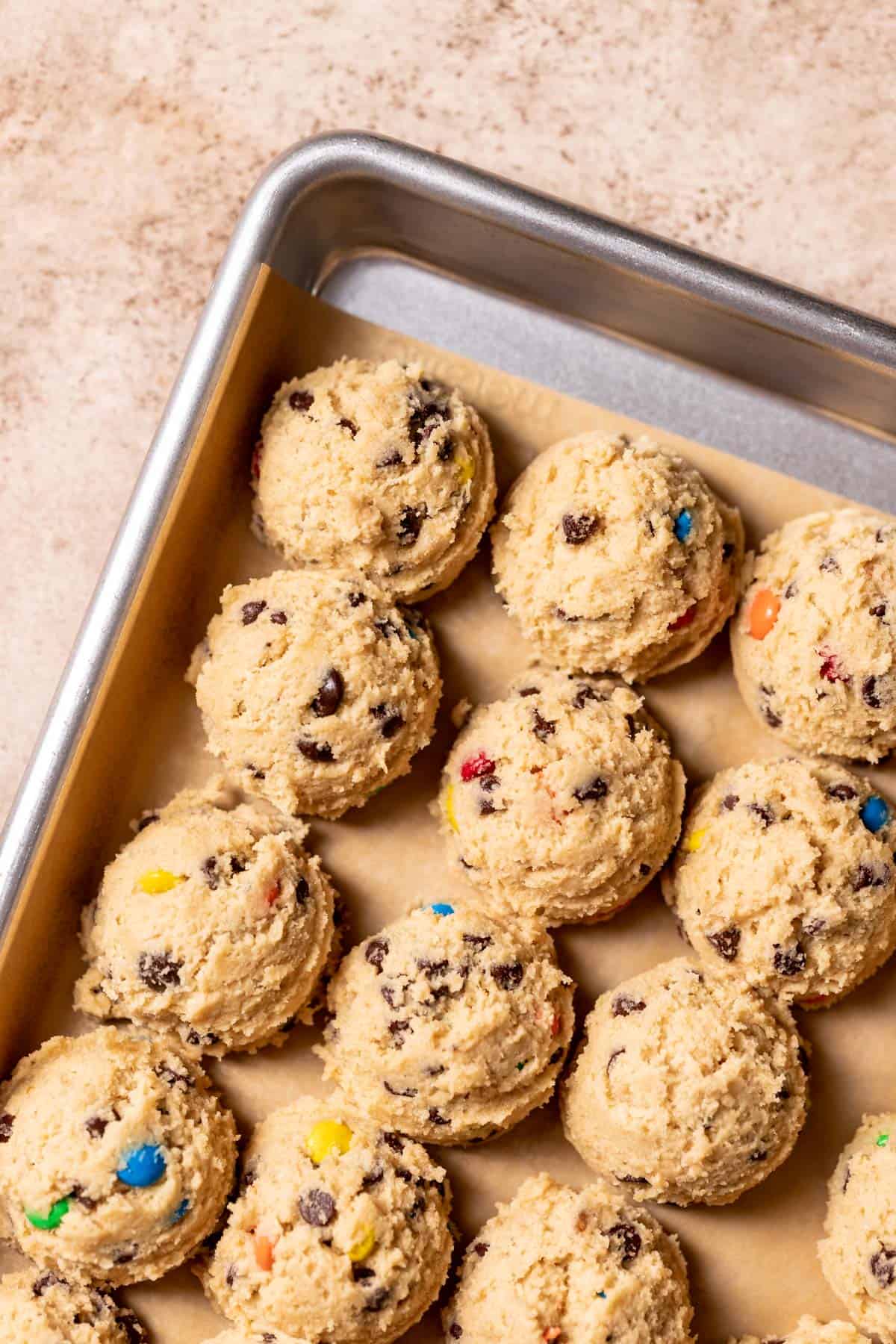 mm cookie dough balls on a baking sheet.
