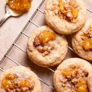 peach cobbler cookies with peach jam and glaze on top.