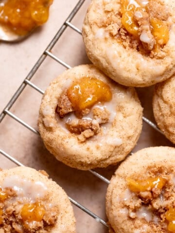peach cobbler cookies with peach jam and glaze on top.