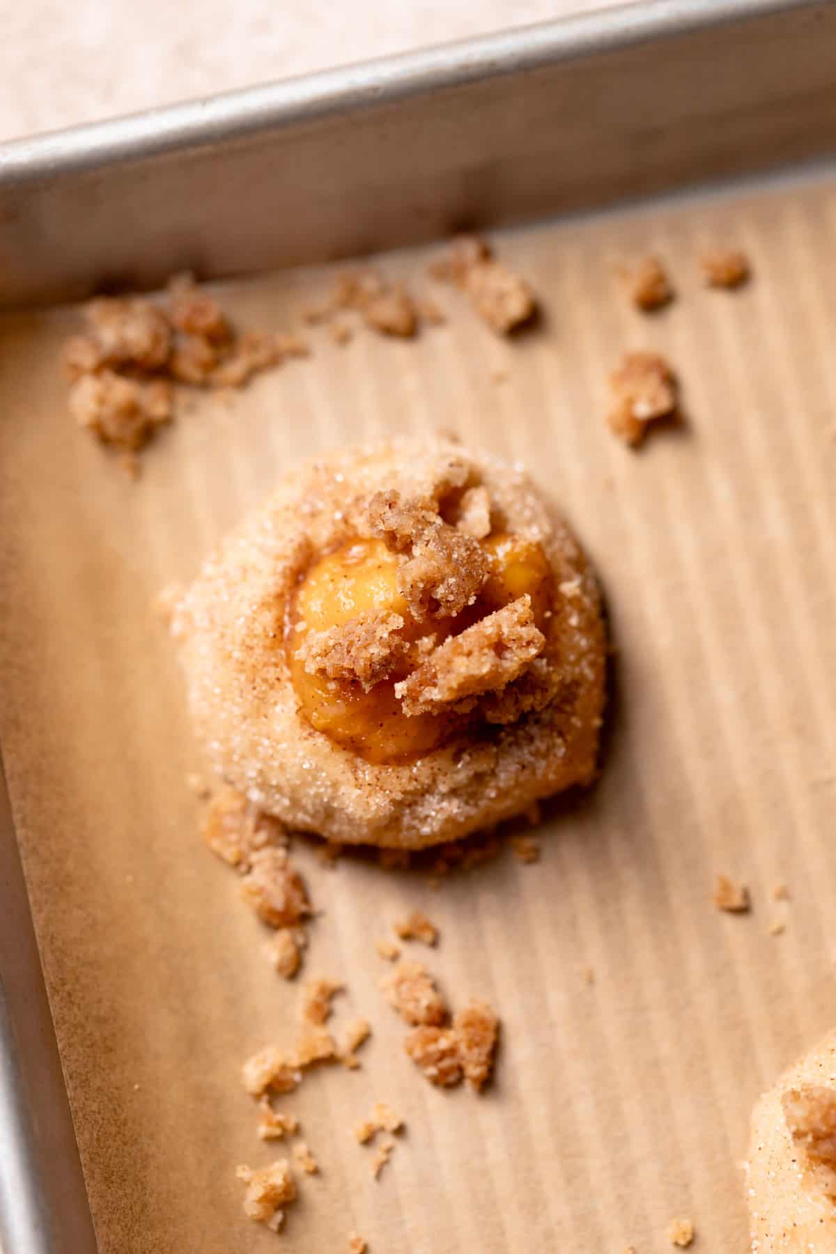 peach cobbler cookie dough ball on a tray before baking.
