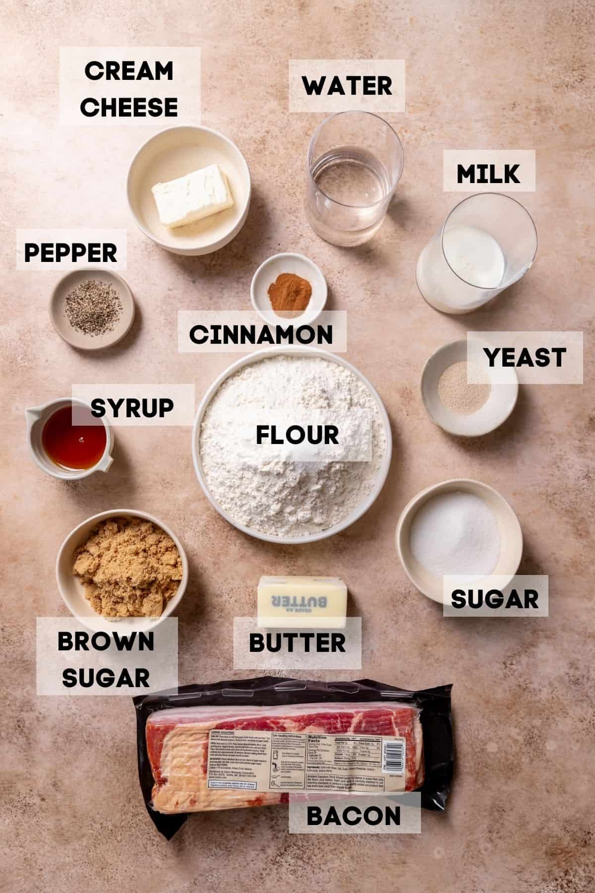 ingredients needed to make cinnamon rolls with bacon in bowls with labels.