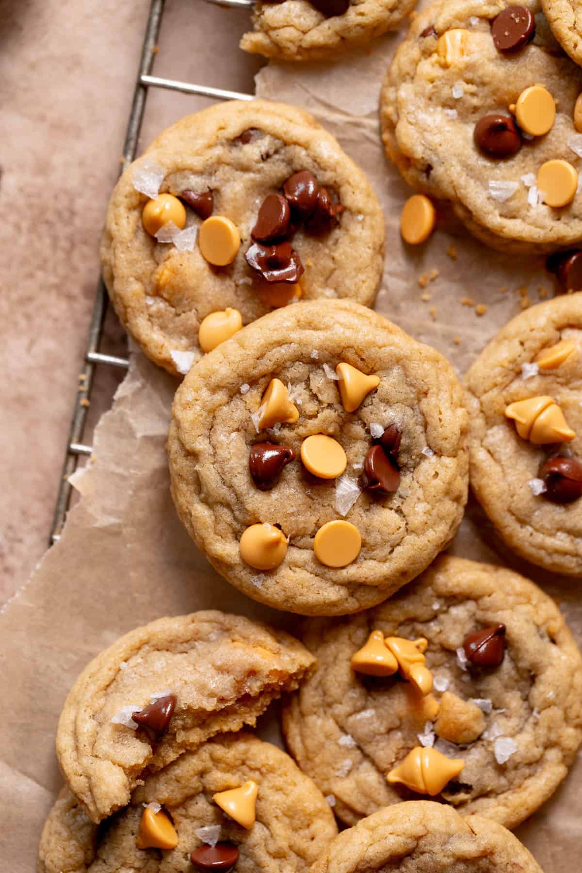 butterscotch chocolate chip cookies in a pile on parchment paper.