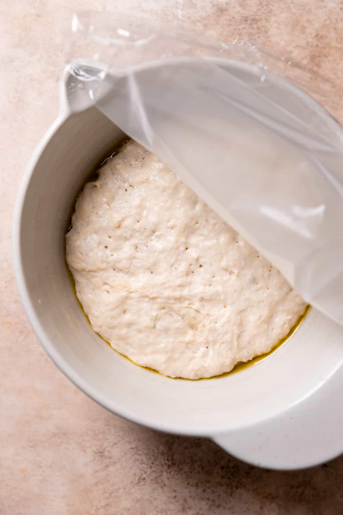 mixing bowl with the focaccia dough after it has doubled in size.
