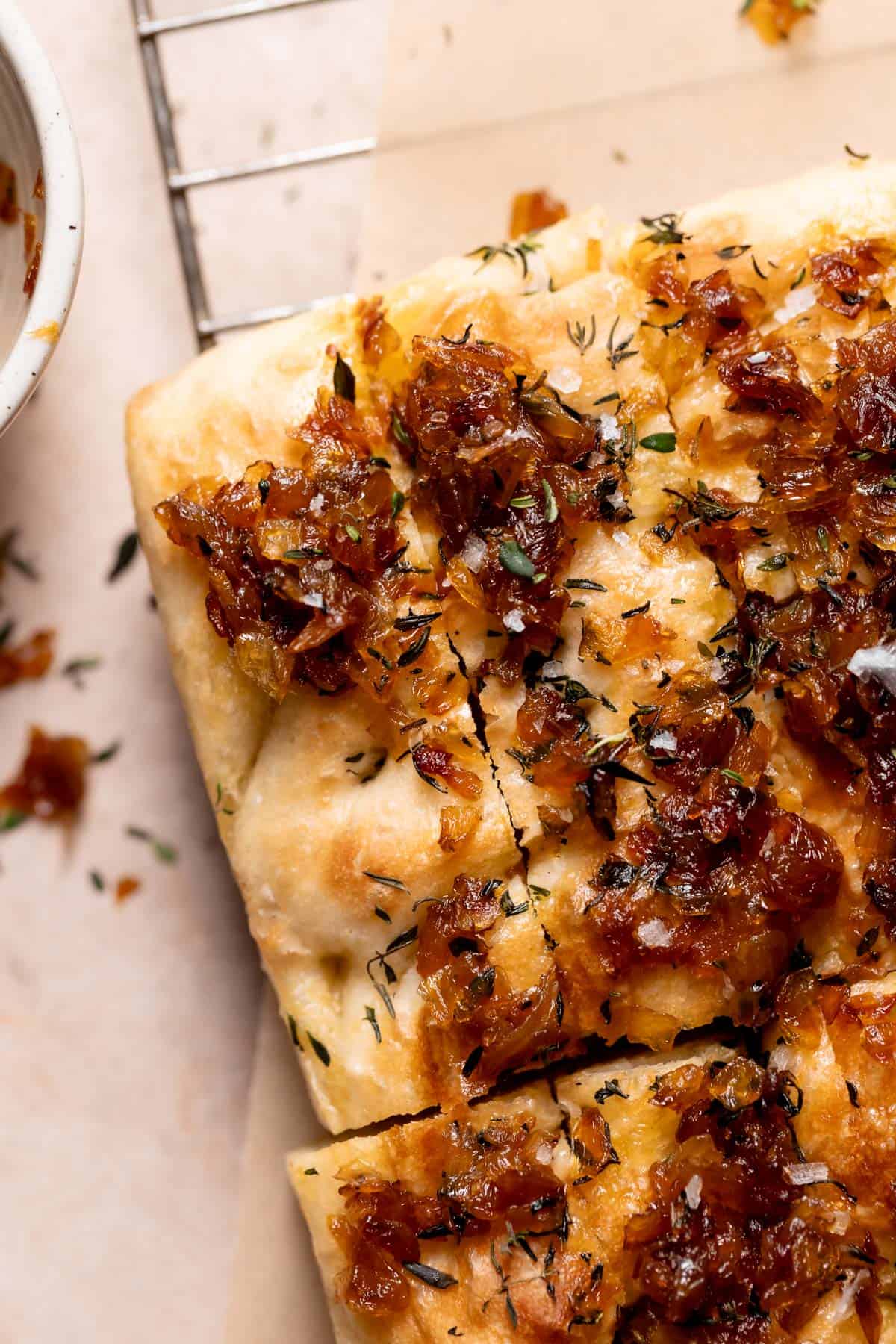 french onion focaccia on a wire cooling rack.