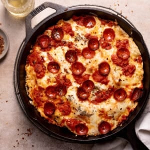 cast iron skillet pizza with cheese and pepperoni.