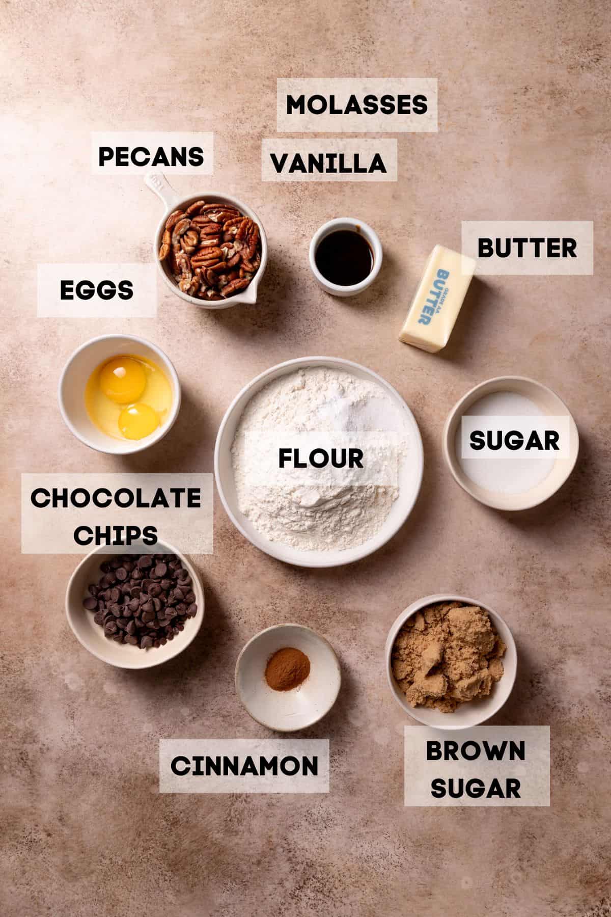 ingredients needed to make chocolate pecan cookies in bowls with labels.