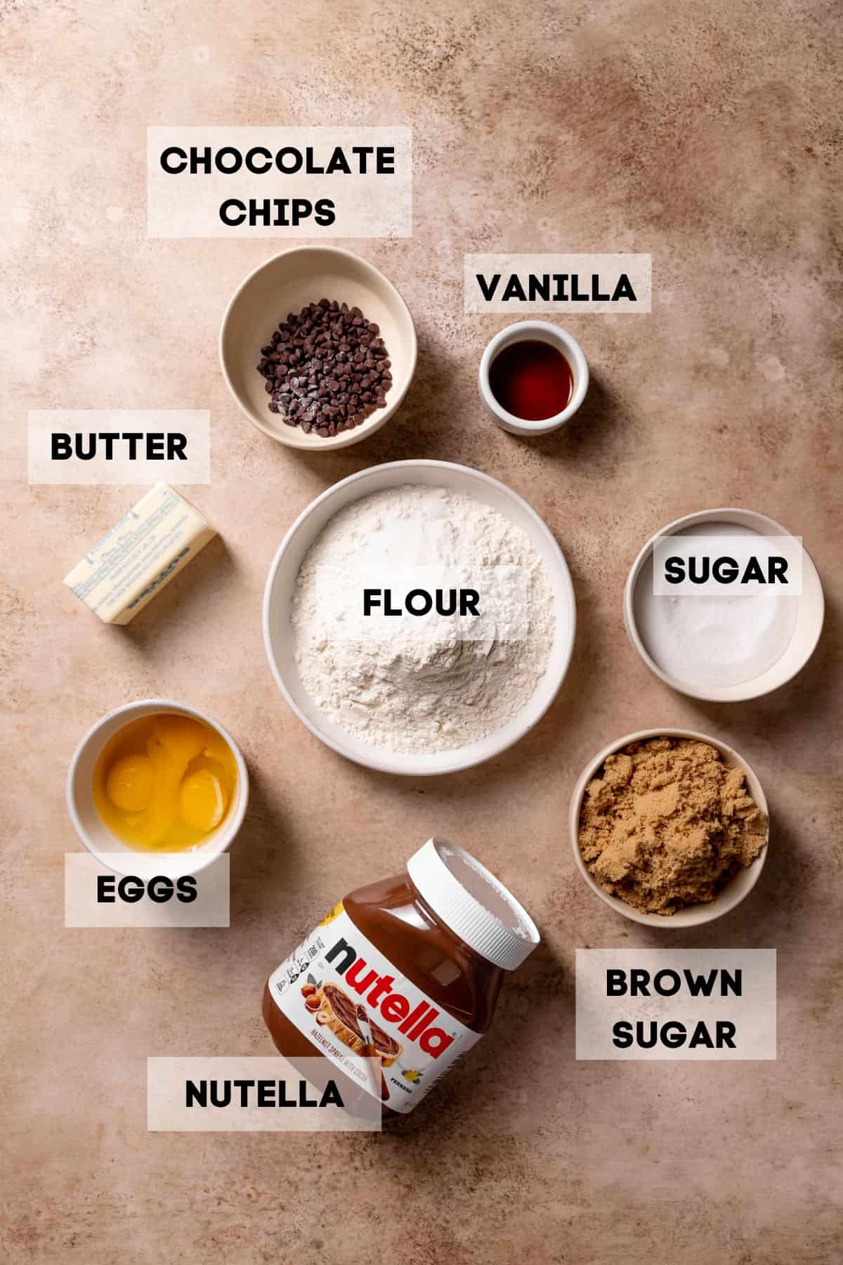 ingredients needed to make nutella bars in bowls with labels.