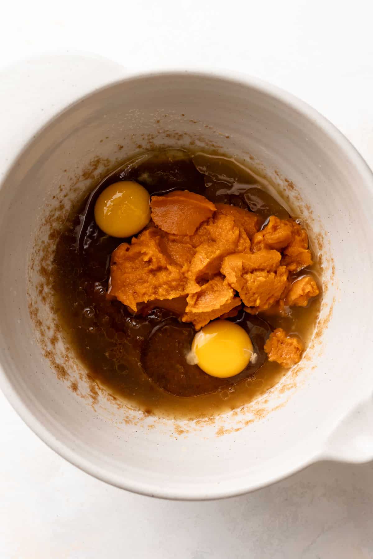 pumpkin puree and egg in a mixing bowl with the butter and sugar.