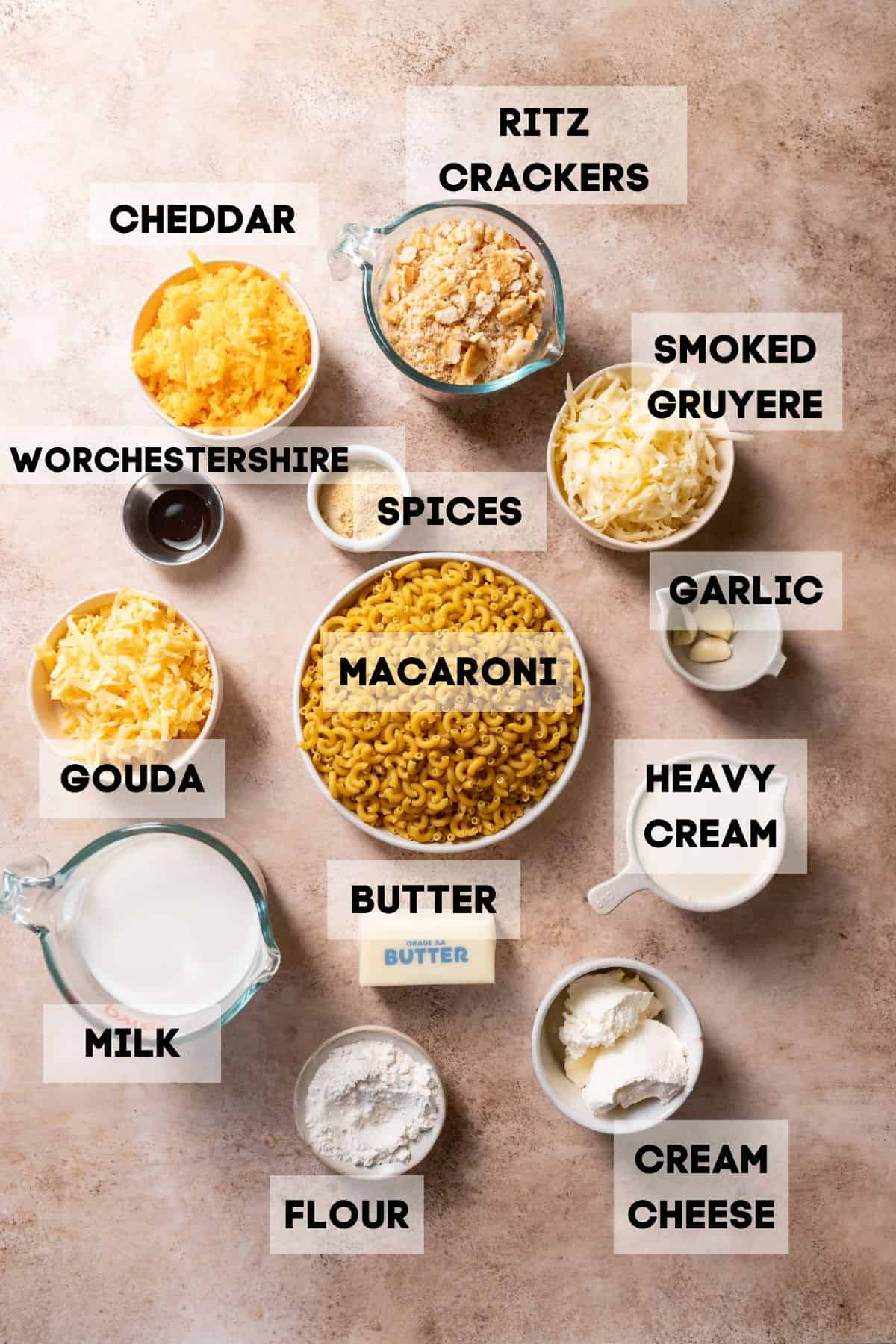 Ingredients needed to make dutch oven macaroni and cheese in bowls with labels.