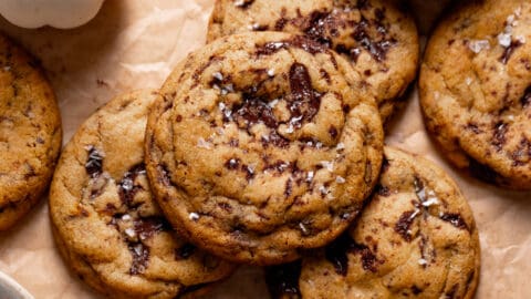 Chocolate chip pumpkin cookies on parchment paper.