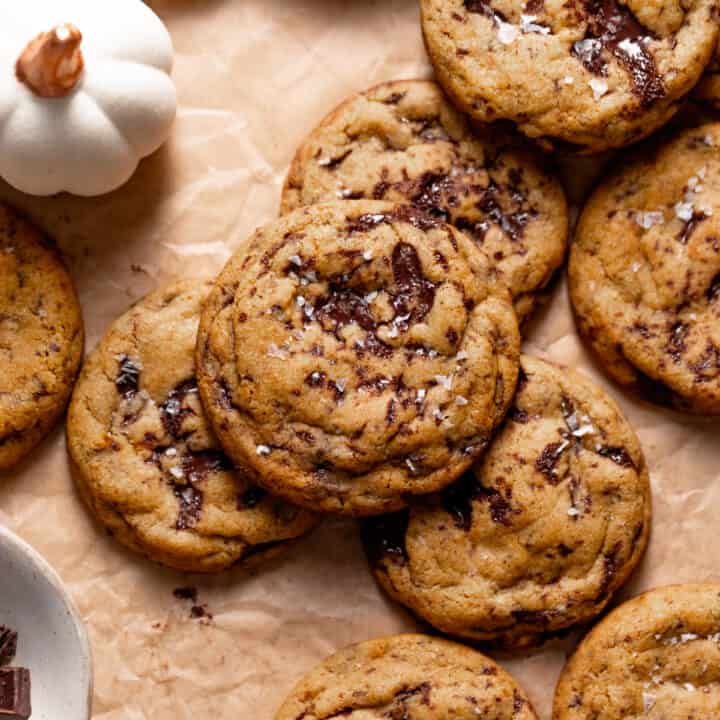 Chocolate chip pumpkin cookies on parchment paper.