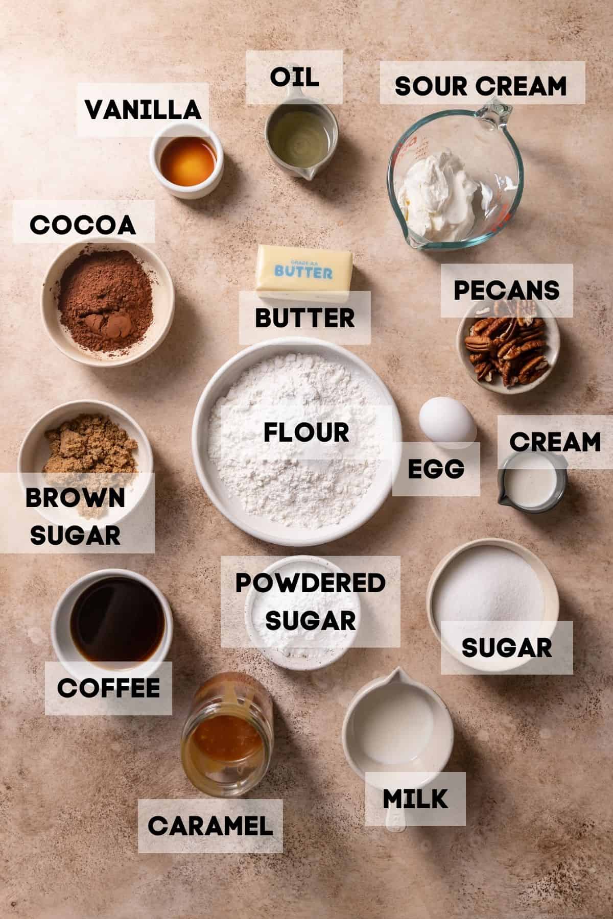 Ingredients needed to make turtle cupcakes in bowls with labels.