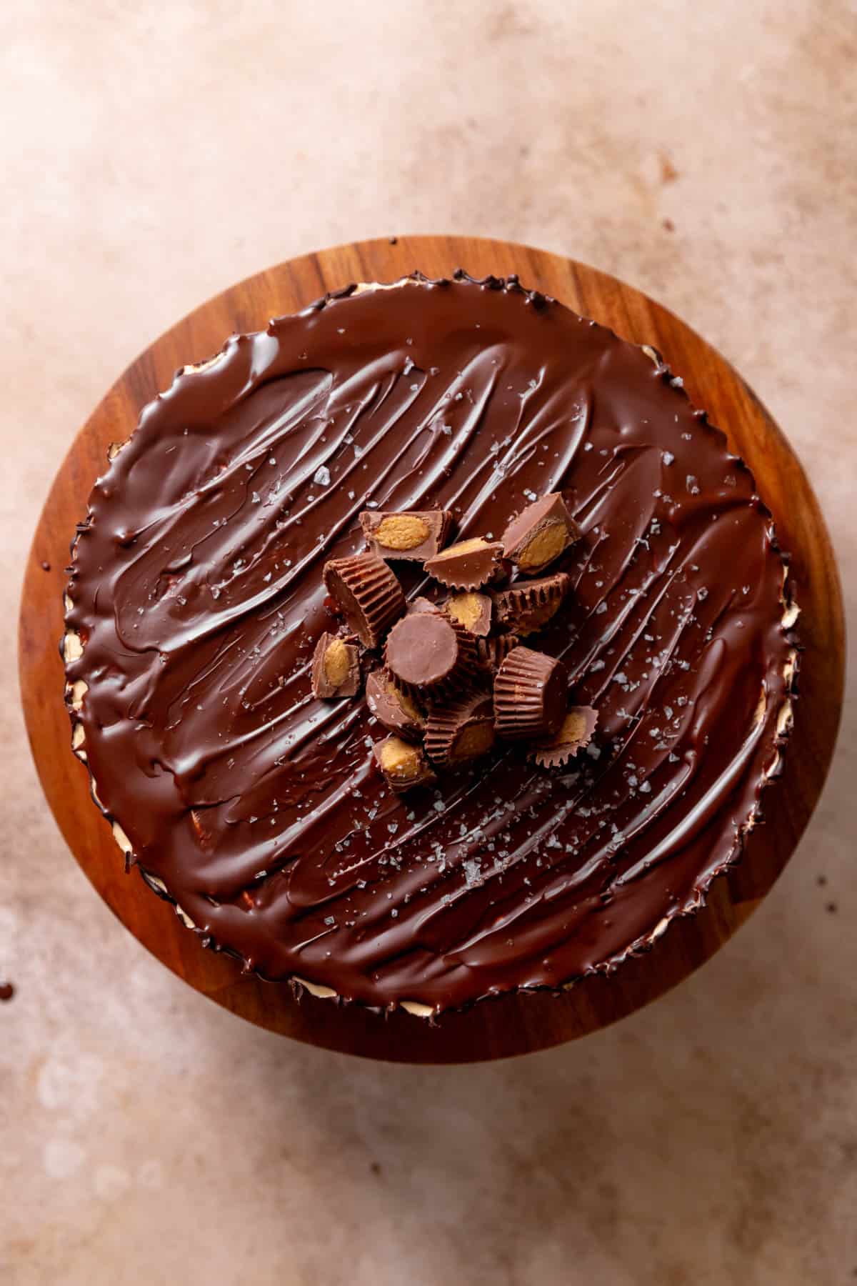 An overhead shot of the top of the Reese's cake to show the chopped peanut butter cups and sea salt.