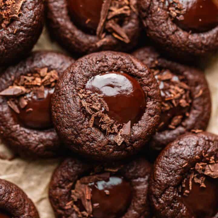 Chocolate thumbprint cookies filled with chocolate ganache and sprinkled with finely chopped chocolate.