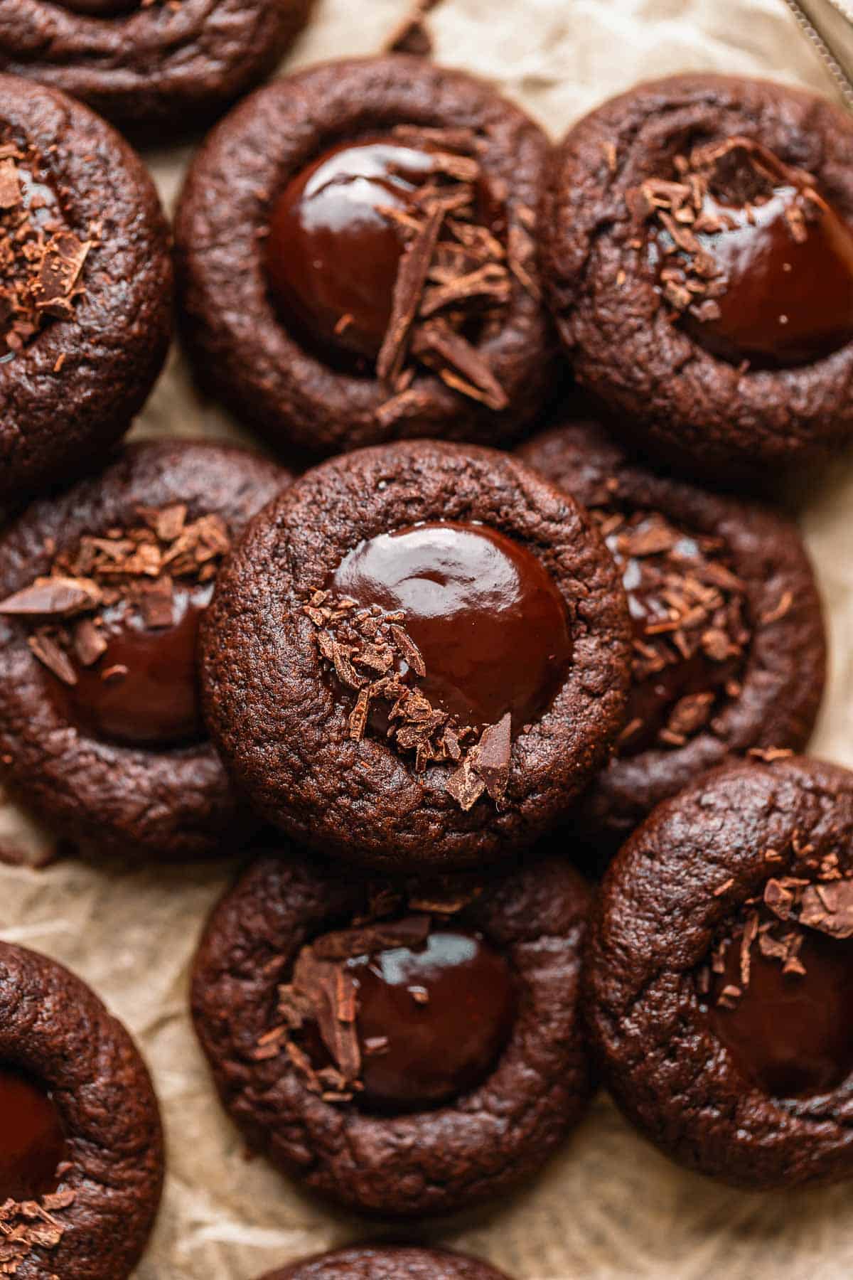 Chocolate thumbprint cookies filled with chocolate ganache and sprinkled with chopped chocolate.