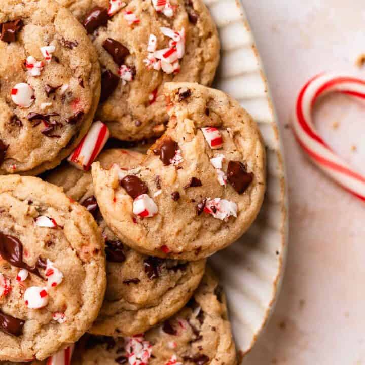 Candy cane chocolate chip cookies on a white serving plate.