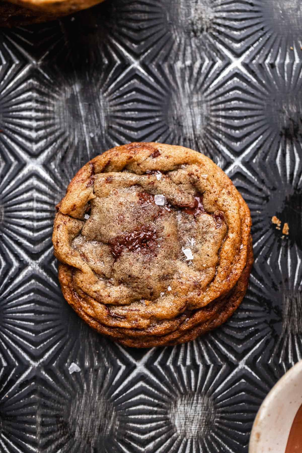 Hazelnut filled cookie on a black baking pan.