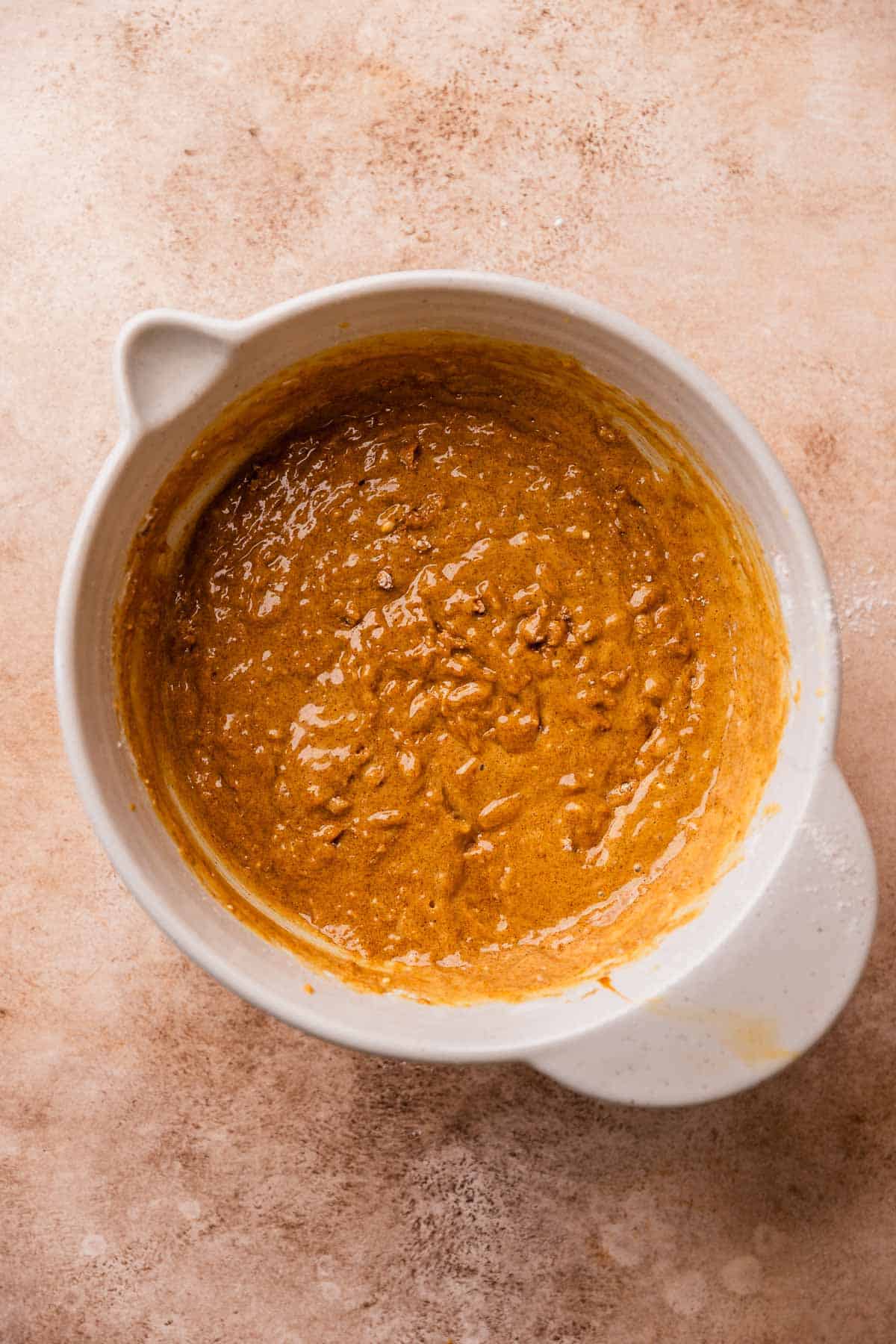 A mixing bowl with the finished gingerbread cake batter.