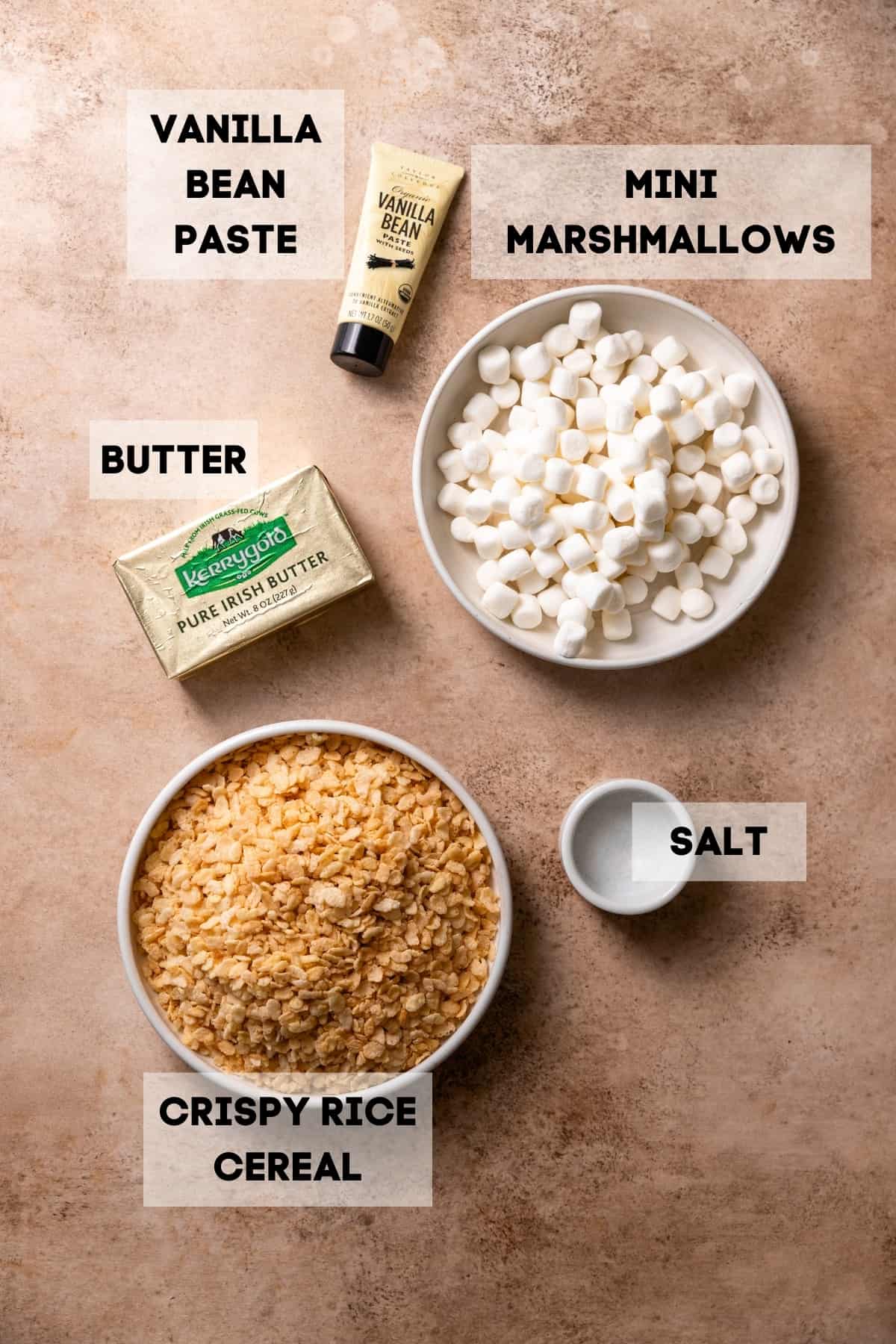 Ingredients needed to make homemade rice krispie treats in bowls with labels.