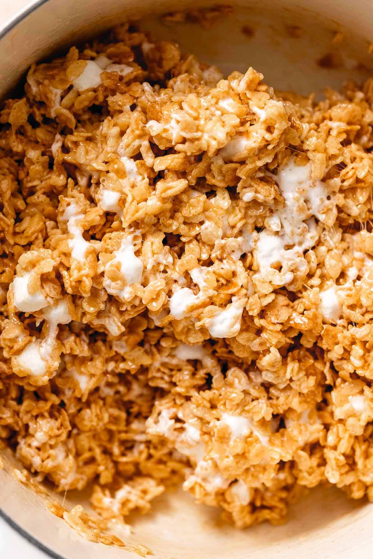 An up close shot of the rice krispie mixture after adding in the extra marshmallows to show their gooey texture.