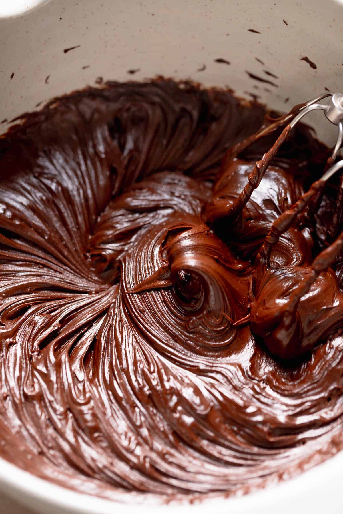 A mixing bowl with the chocolate fudge frosting after beating.