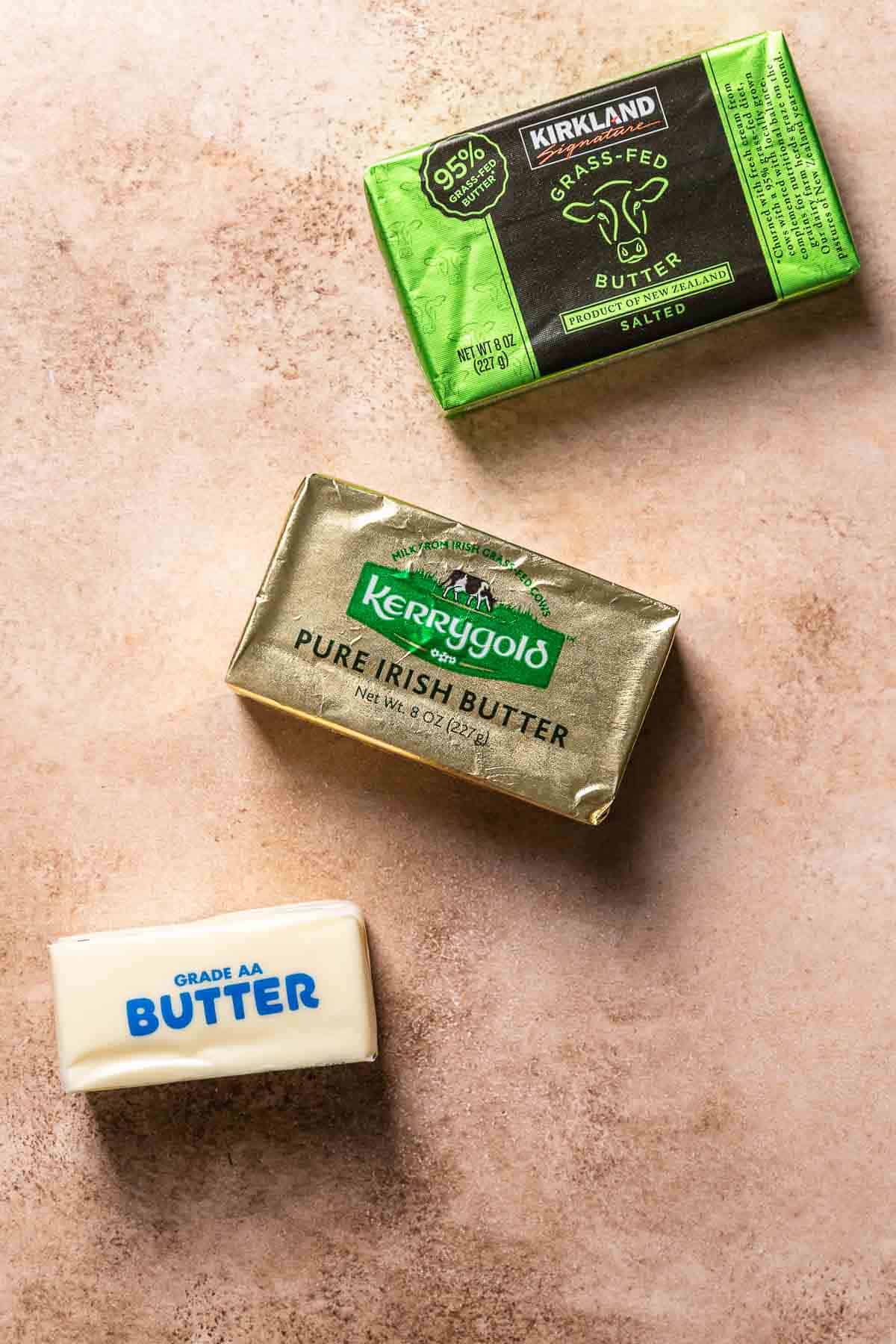 Sticks of butter on a brown backdrop.