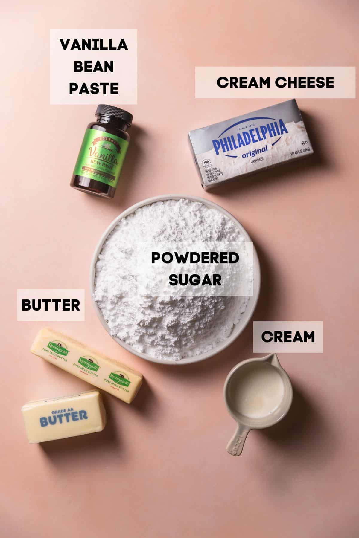 Ingredients needed to make cream cheese icing in bowls with labels.