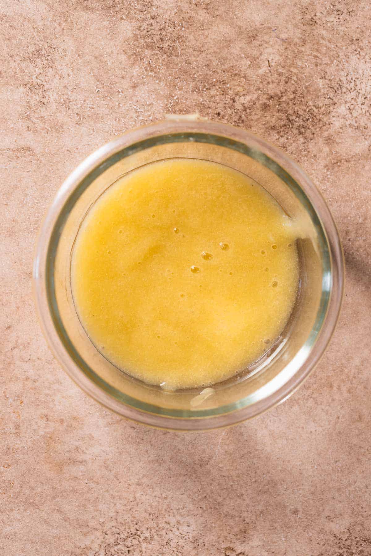 A glass bowl with the blended lemon puree.