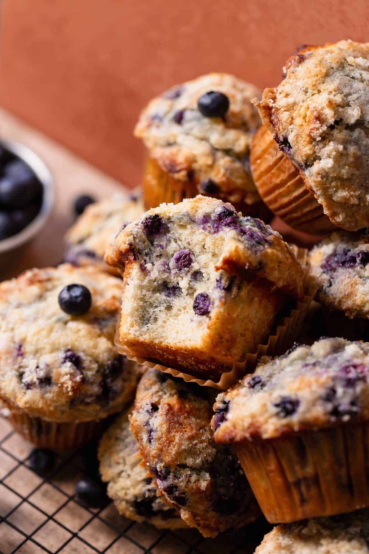 A blueberry muffin with a bite taken out of it to show the moist and fluffy texture.