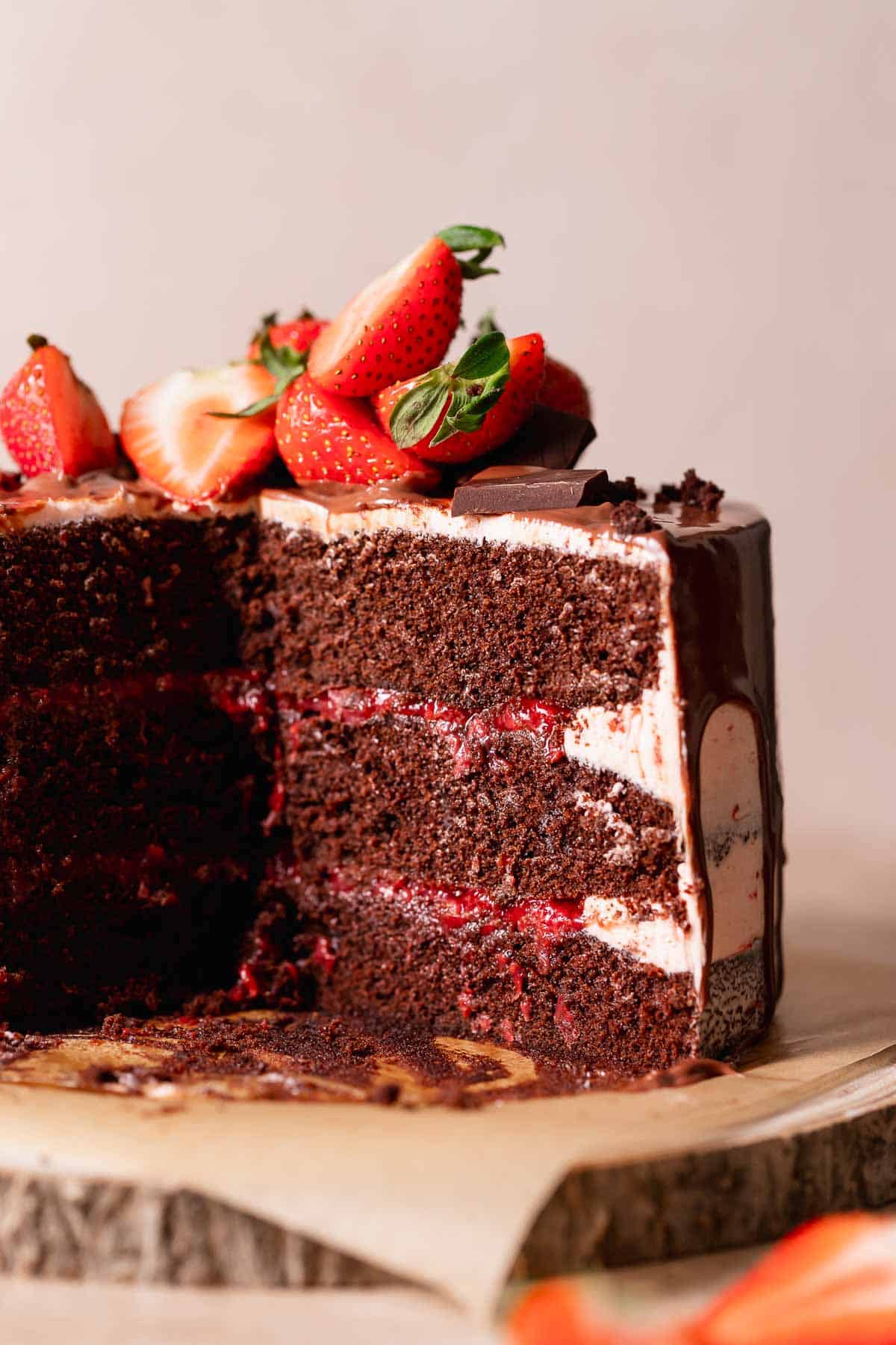 Chocolate cake with strawberry filling cut in half to show the layers.