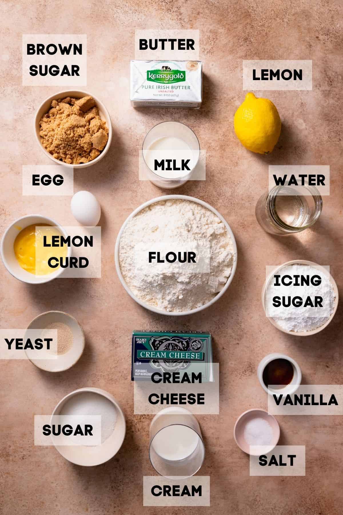 Ingredients needed to make lemon cinnamon rolls in bowls with labels.