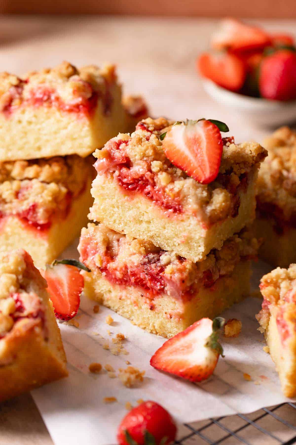 Strawberry crumb cake slices stacked on top of each other.