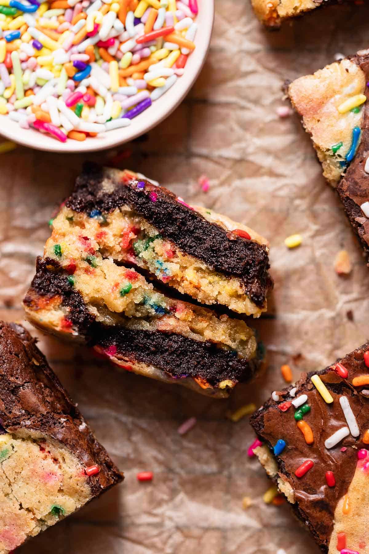 A birthday cake brownie split in half to show the fudgy texture.