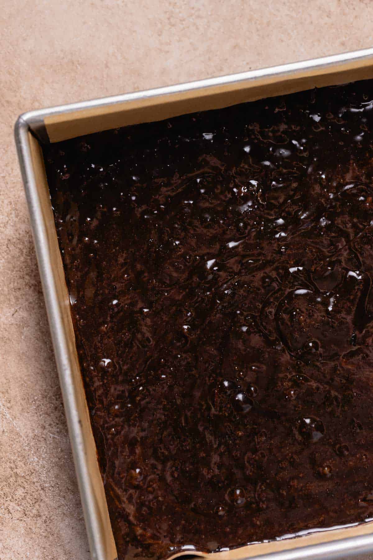 A baking pan full of the brownie batter before baking.