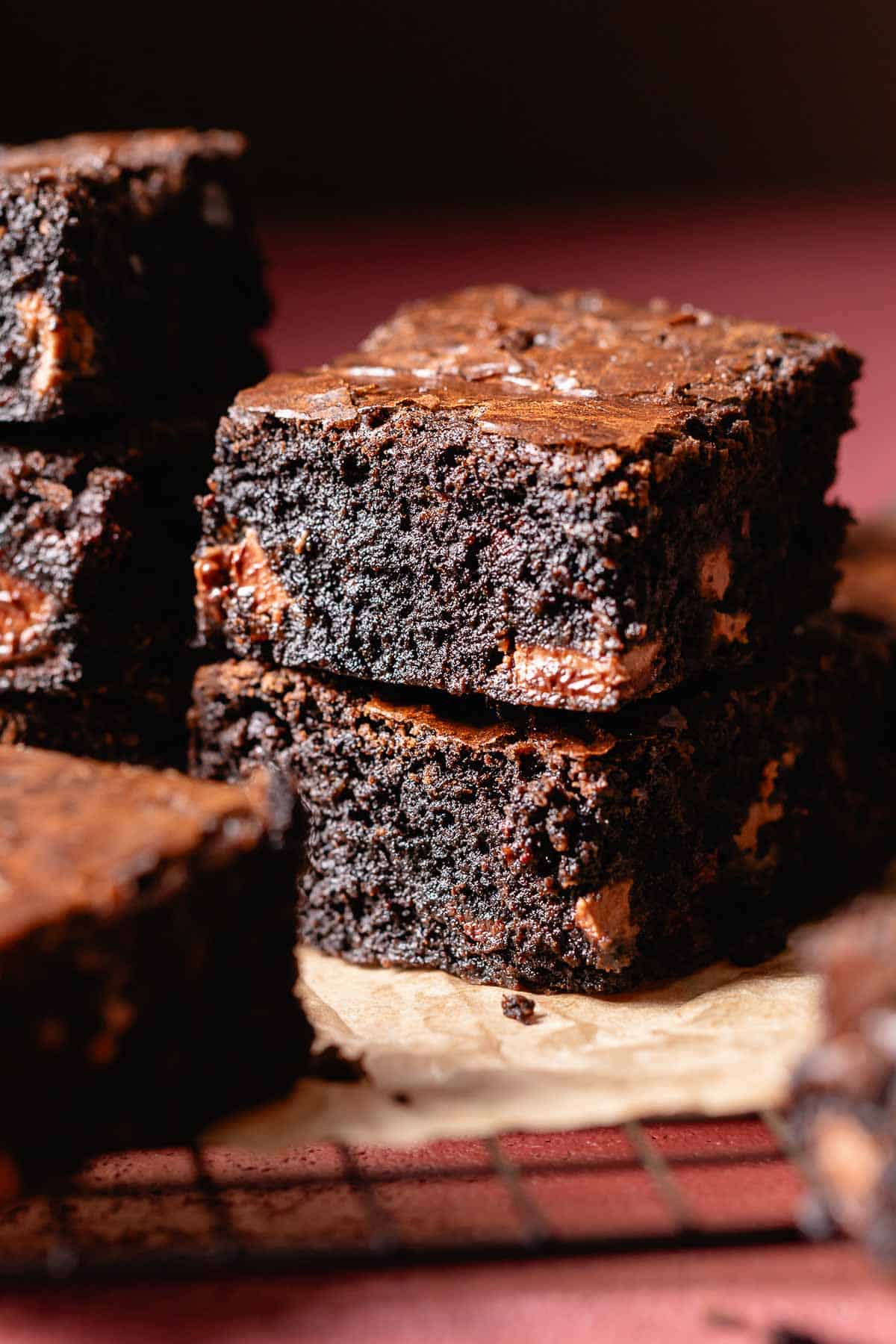 Two miso brownies stacked on top of each other to show the fudgy texture.