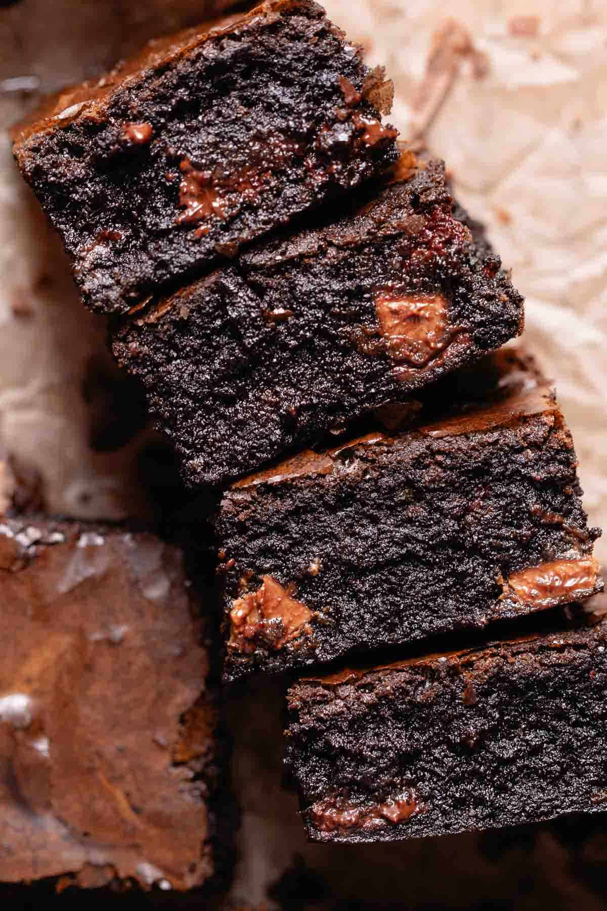 A stack of miso brownies on their sides to show the fudgy texture.