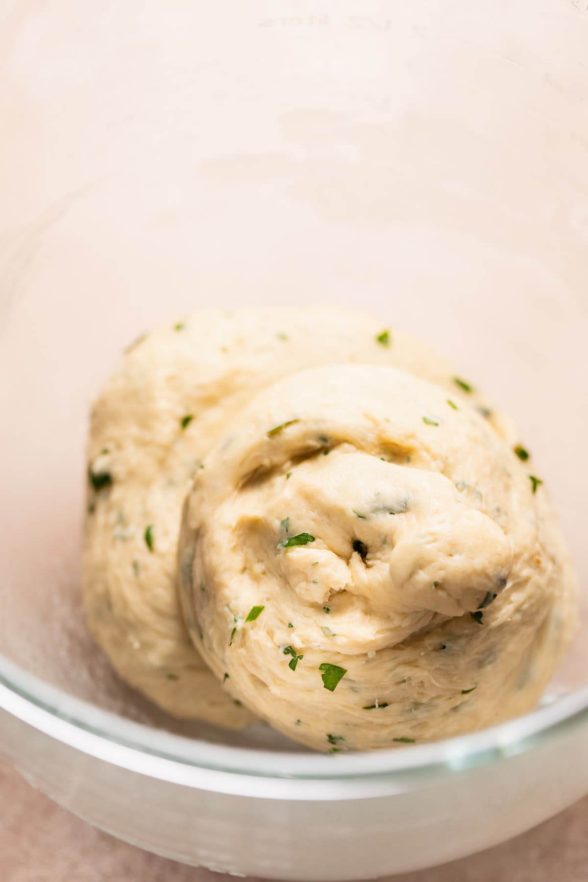 The kneaded garlic bun dough in a mixing bowl.